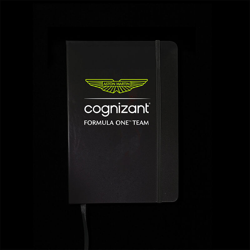 Black notebook with Aston Martin and Cognizant branding on a black background
