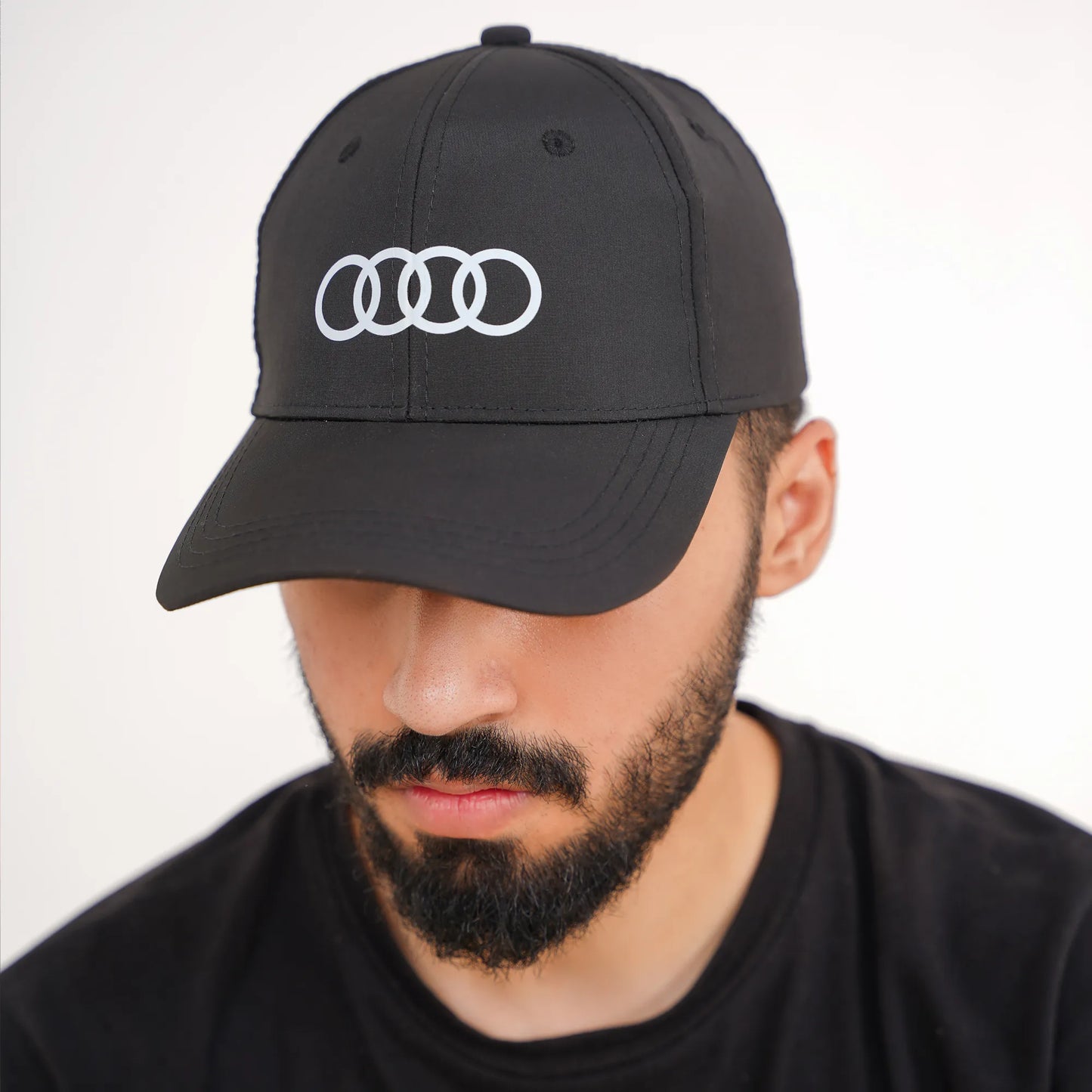 Man wearing a black cap with Audi logo premium quality