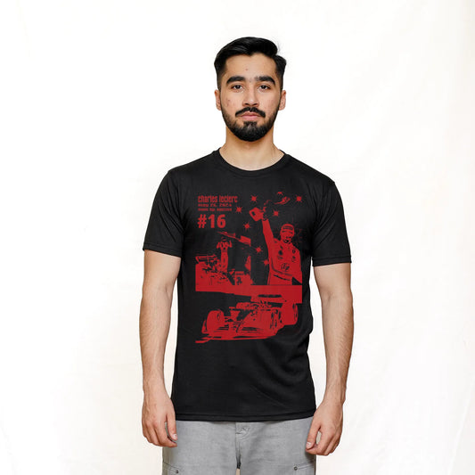 A man wearing a black short-sleeved T-shirt with a graphic print of a racing scene in red and white, representing Scuderia Ferrari F1.