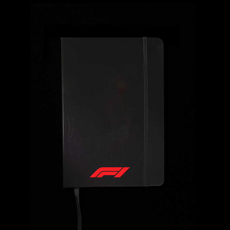 Black notebook with a red logo on a black background
