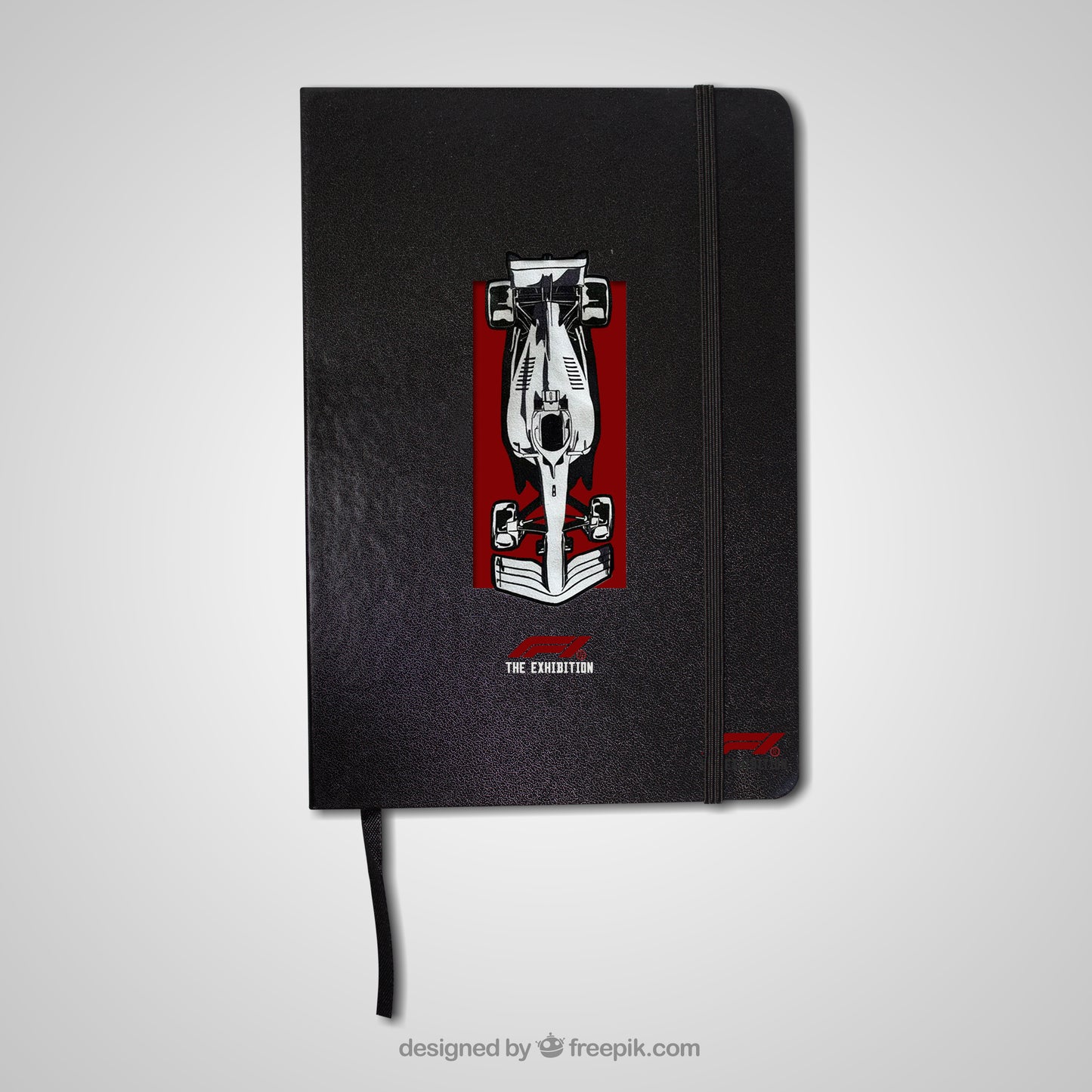 Black notebook with a red and white design on the cover against a light gray background