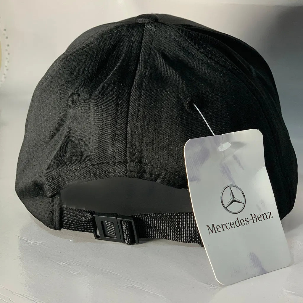 Black cap with a Racing Collection-Benz tag on a light gray background