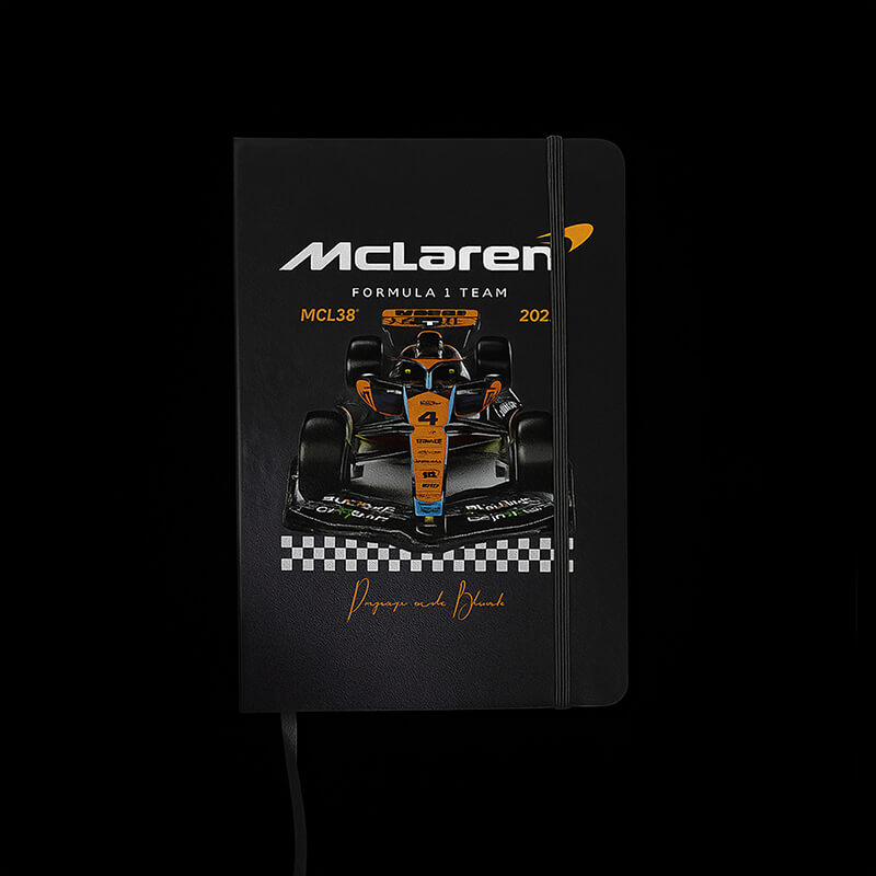 Black notebook with McLaren Formula 1 Team design on a black background
