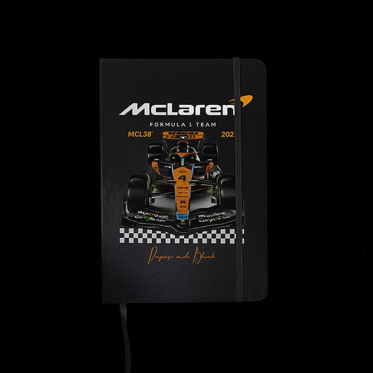 Black notebook with McLaren Formula 1 Team design on a black background