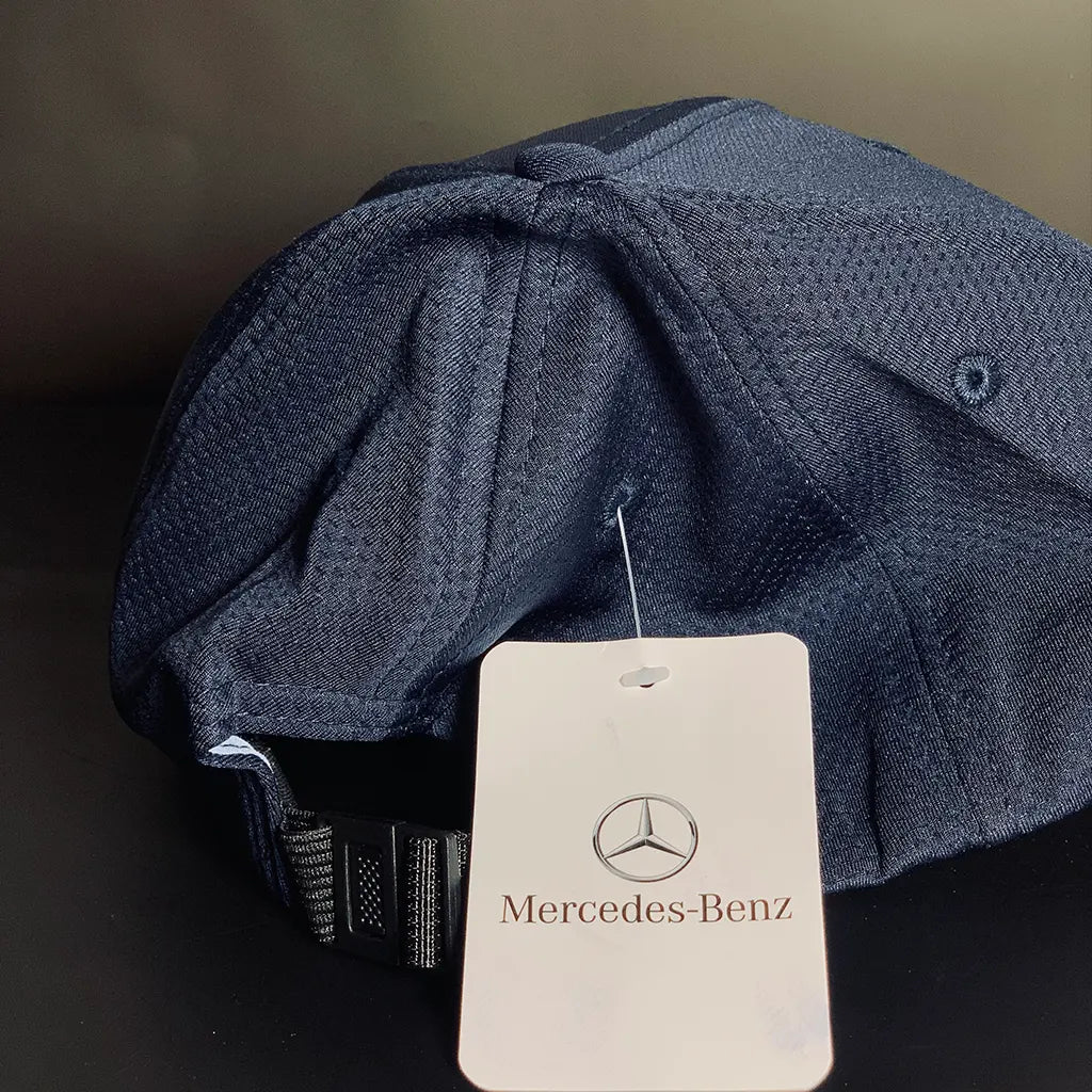 Blue textured cap with a Racing Collection-Benz tag on a dark background