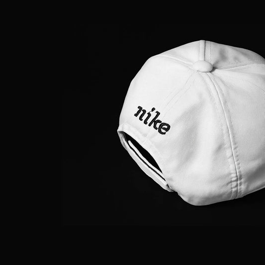 White Nike cap on a black background