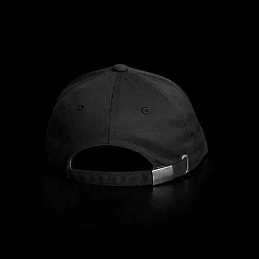Black cap with a metal buckle on a black background