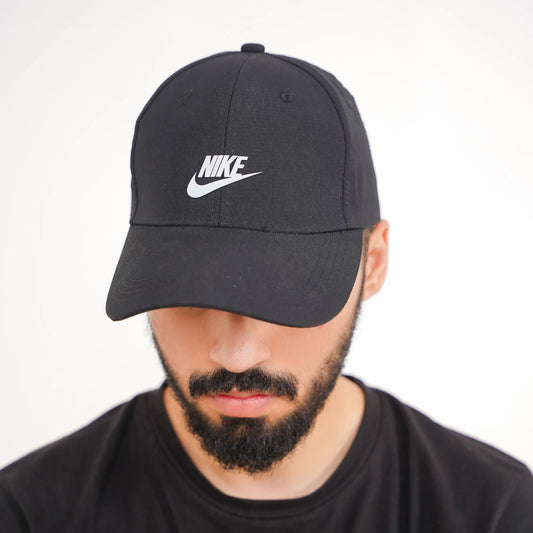 Man wearing a black Nike cap against a white background