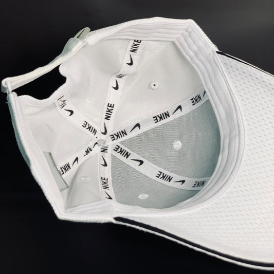 White Nike cap with brand logo on a black background