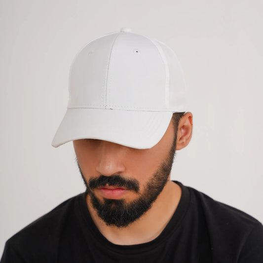 Man wearing a white cap and black shirt on a light gray background