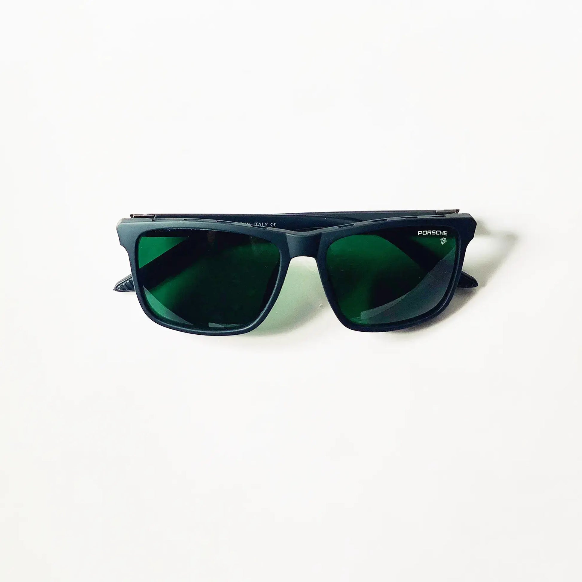 Sunglasses with green lenses on a white background