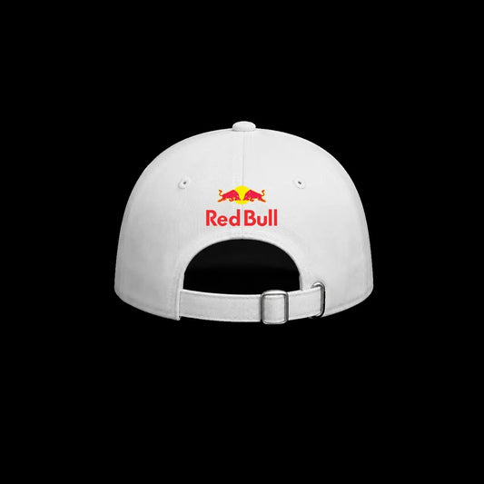 A white baseball cap shown from the back, featuring the red and yellow Red Bull logo and text embroidered on the center front, set against a solid black background.