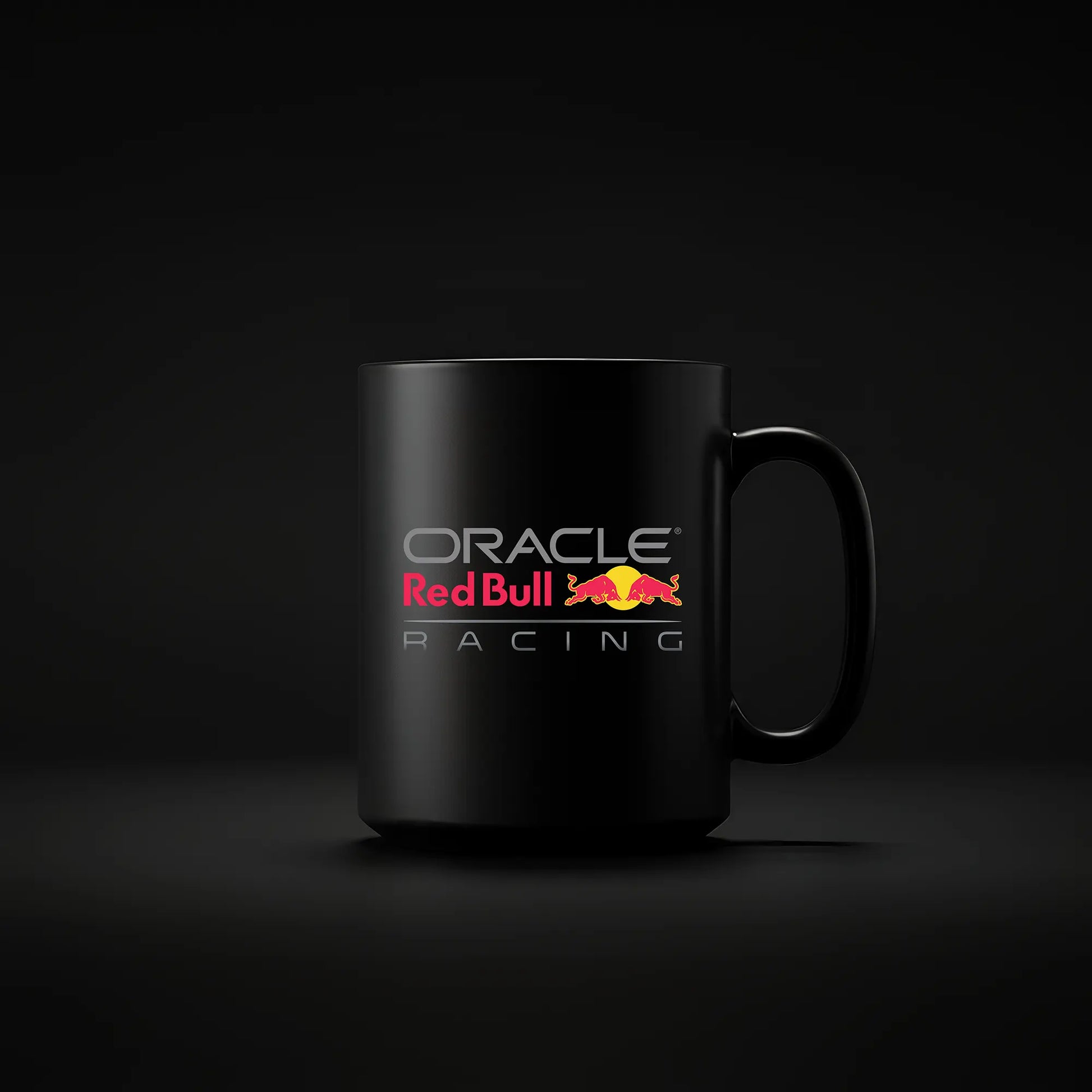 A black ceramic mug with the Red Bull logo and the text 'ORACLE RED BULL RACING' printed on the front.