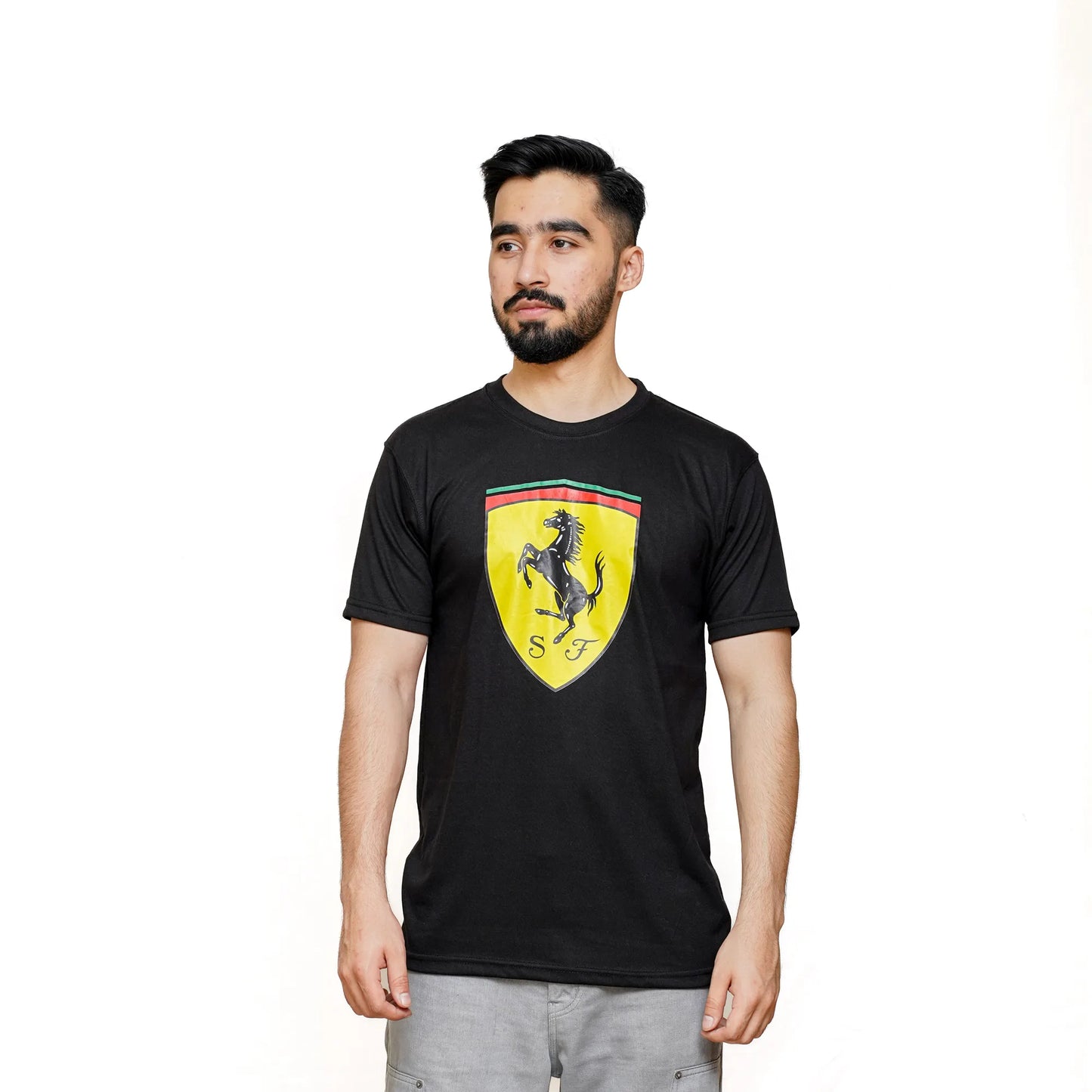 A man wearing a black short-sleeved T-shirt with a Ferrari logo in yellow on the chest.