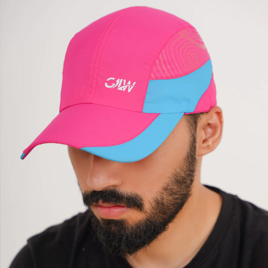 Person wearing a pink and blue cap with a brand logo on a light gray background