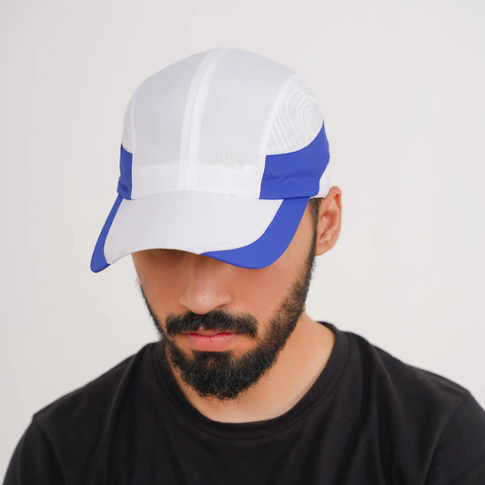 Man wearing a white and blue cap on a plain background