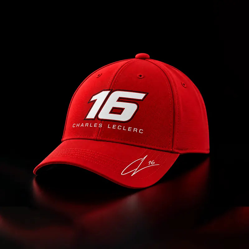 A red baseball cap featuring the number 16 in white with a black outline, the text 'CHARLES LECLERC' below it, and a white signature on the brim, shown against a black background.
