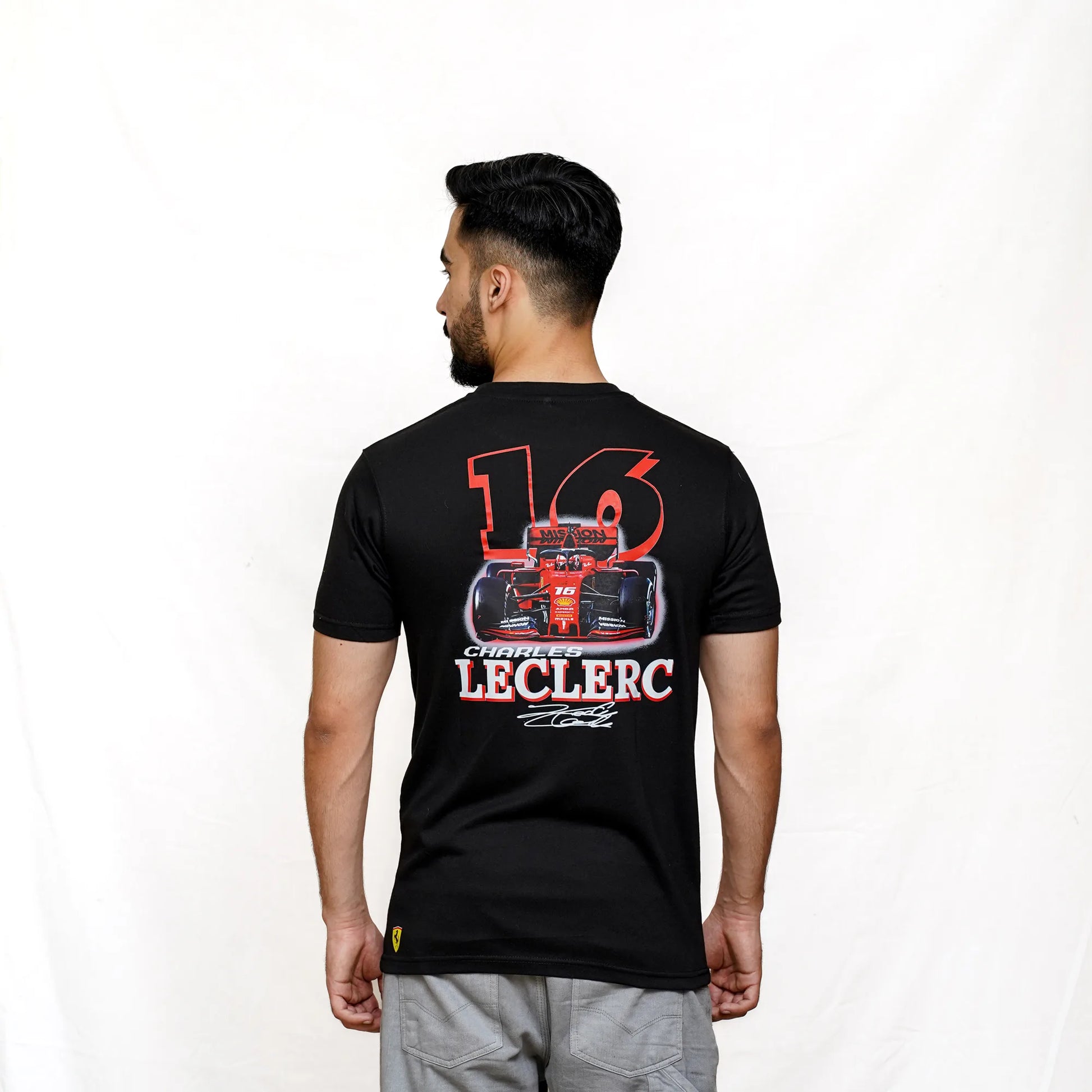 A person wearing a black short-sleeved t-shirt with '16' and 'LECLERC' text design on the back.