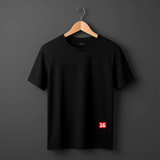 A black short-sleeve crewneck t-shirt hanging on a wooden hanger against a dark gray background. The shirt features a small red square graphic on the lower right side containing the white number '16'.