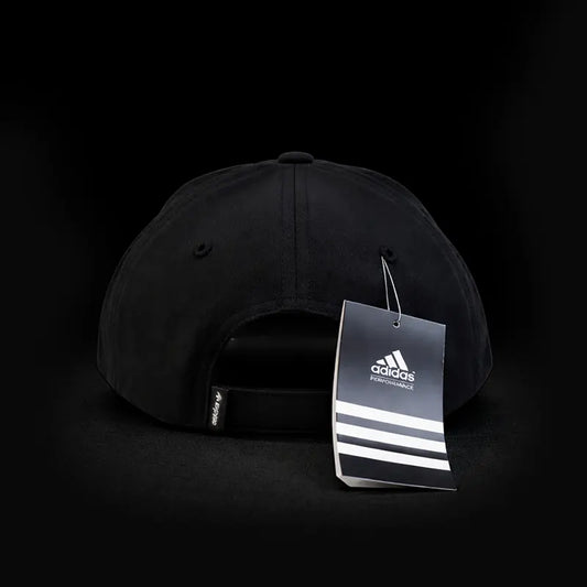 Black Adidas cap with a tag on a black background