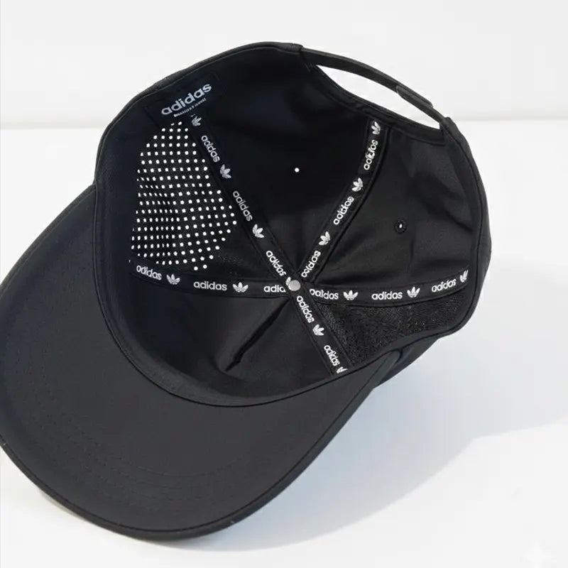 Black Adidas cap with rhinestone embellishments on a white background