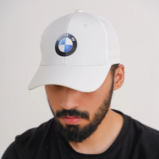 Man wearing a white cap with BMW logo on a plain background