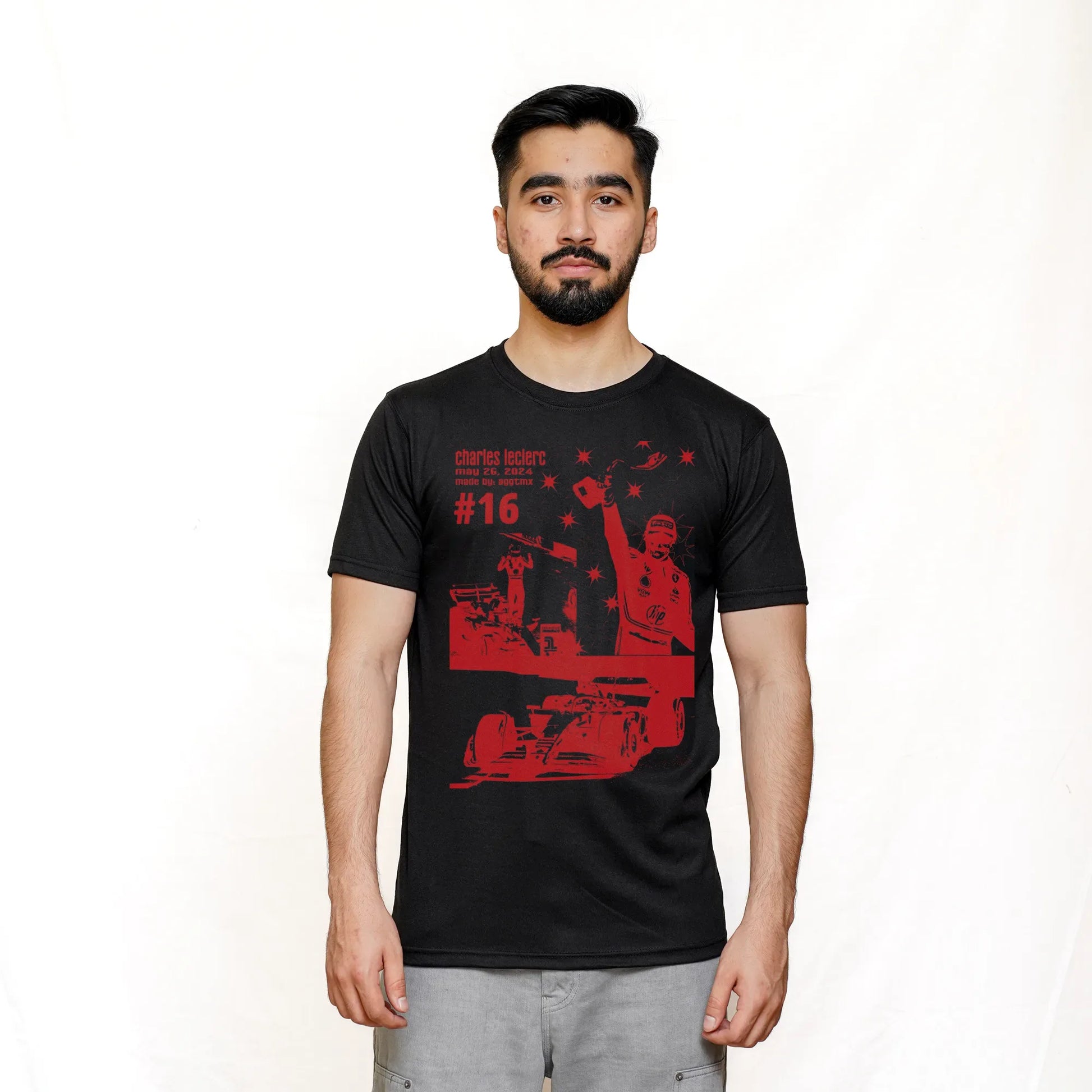 A man wearing a black short-sleeved T-shirt with a graphic print of a racing scene in red and white, representing Scuderia Ferrari F1.