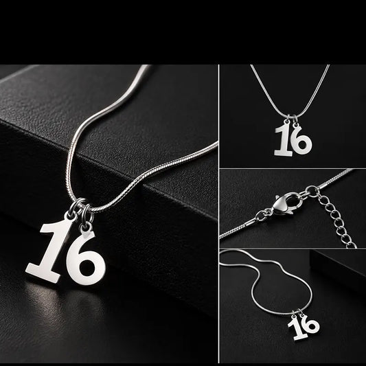 Close-up of silver number 16 racing pendant design