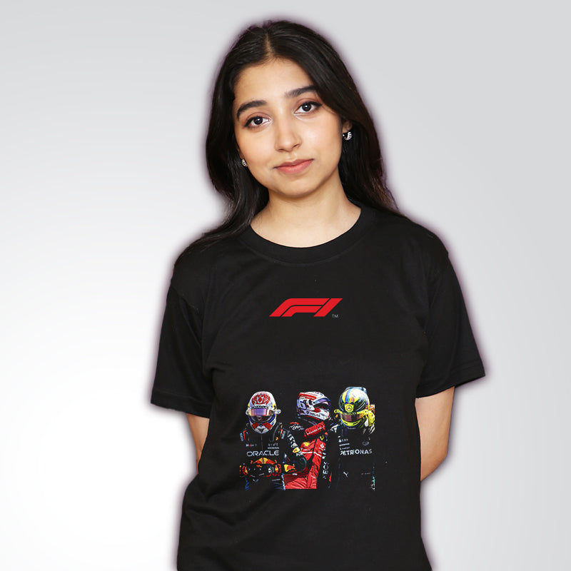 A person wearing a black Formula 1 t-shirt with graphics of racing drivers and the F1 logo.