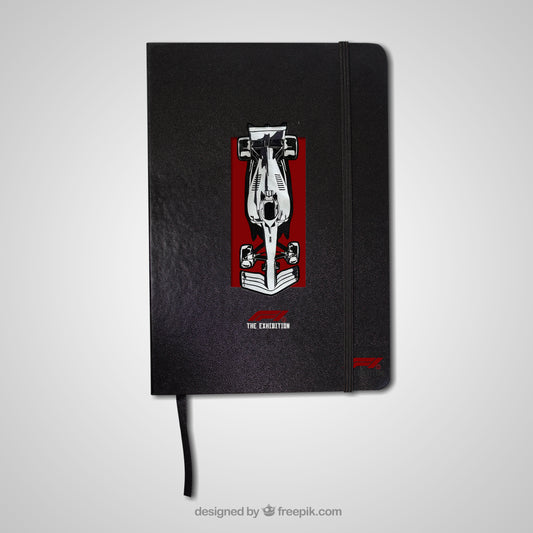Black notebook with a red and white design on the cover against a light gray background