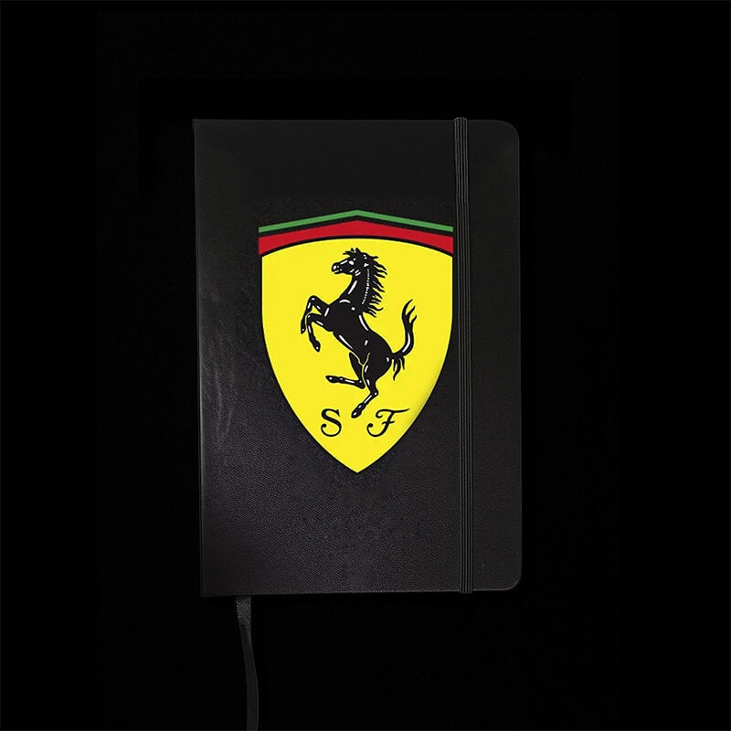 Black notebook with Ferrari logo on a black background