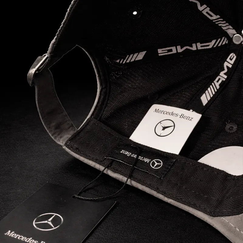 Black cap with Racing Collection-Benz AMG logo on a dark background