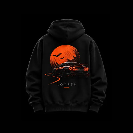 Black oversized Halloween racing hoodie back view with large orange moon, bats and a sports car with red tail lights on a winding road, Loopzs