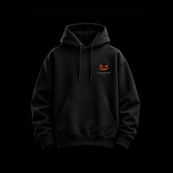 Black oversized hoodie front view with small glowing orange pumpkin face and Loopzs wordmark on the chest, kangaroo pocket and drawstring hood