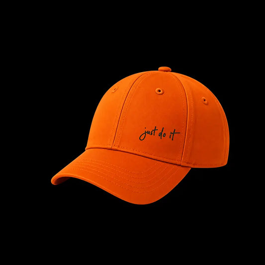A bright orange baseball cap with the phrase 'just do it' embroidered in black script on the front, shown against a solid black background.