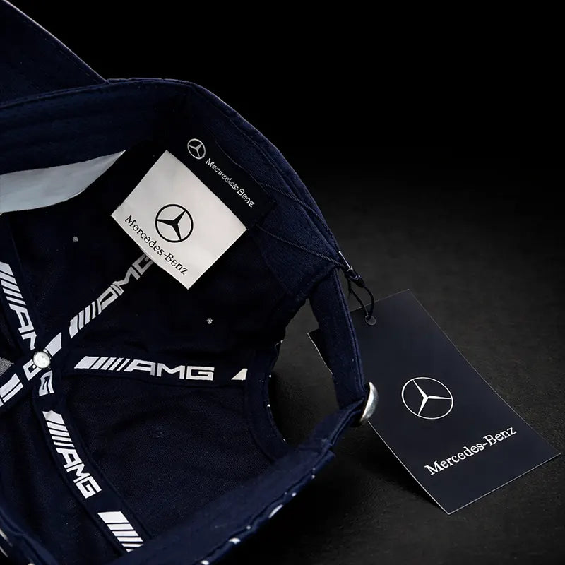 Navy blue backpack with Mercedes-Benz logo and AMG branding on a dark background