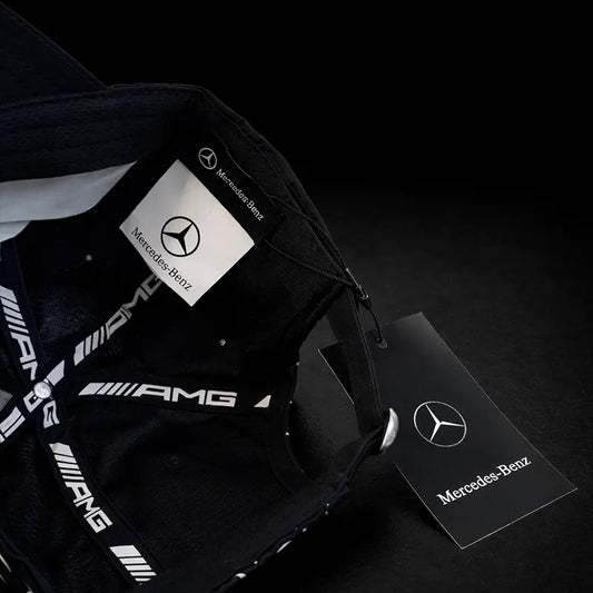 Black Mercedes-Benz backpack with branded cards on a dark background