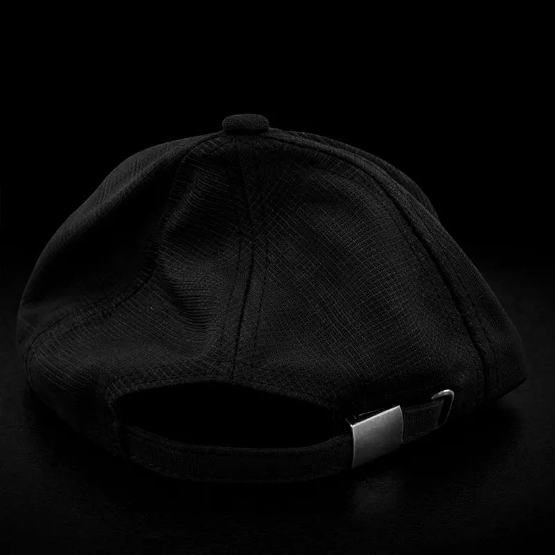 Black baseball cap on a black background