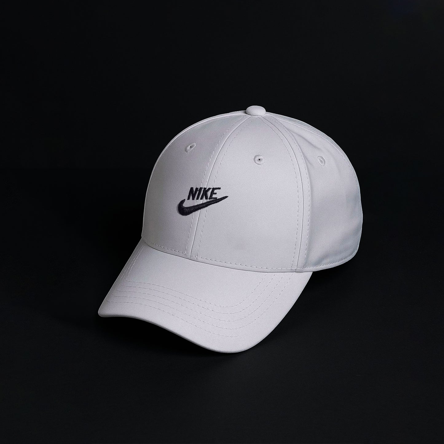 Gray cap with Nike logo on a black background