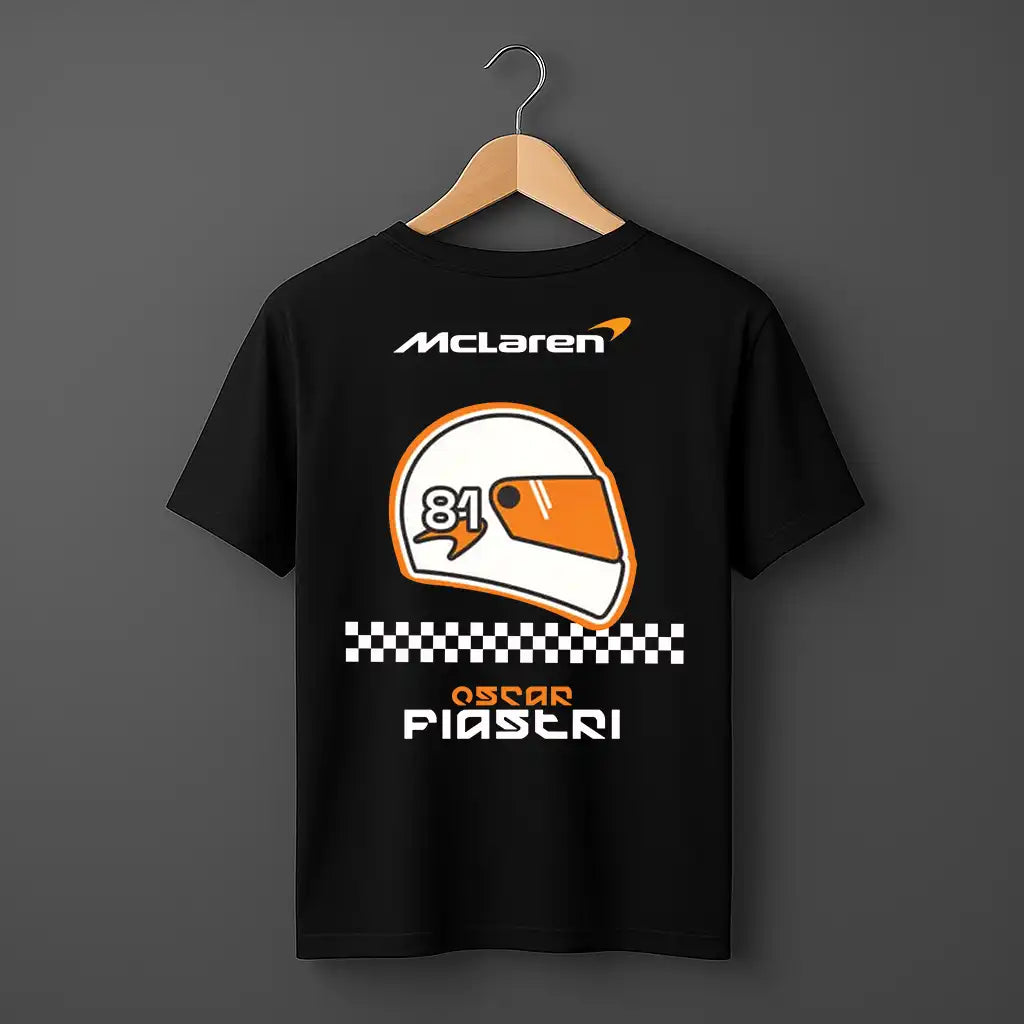 Black t-shirt with McLaren logo and racing helmet design on a hanger against a dark background