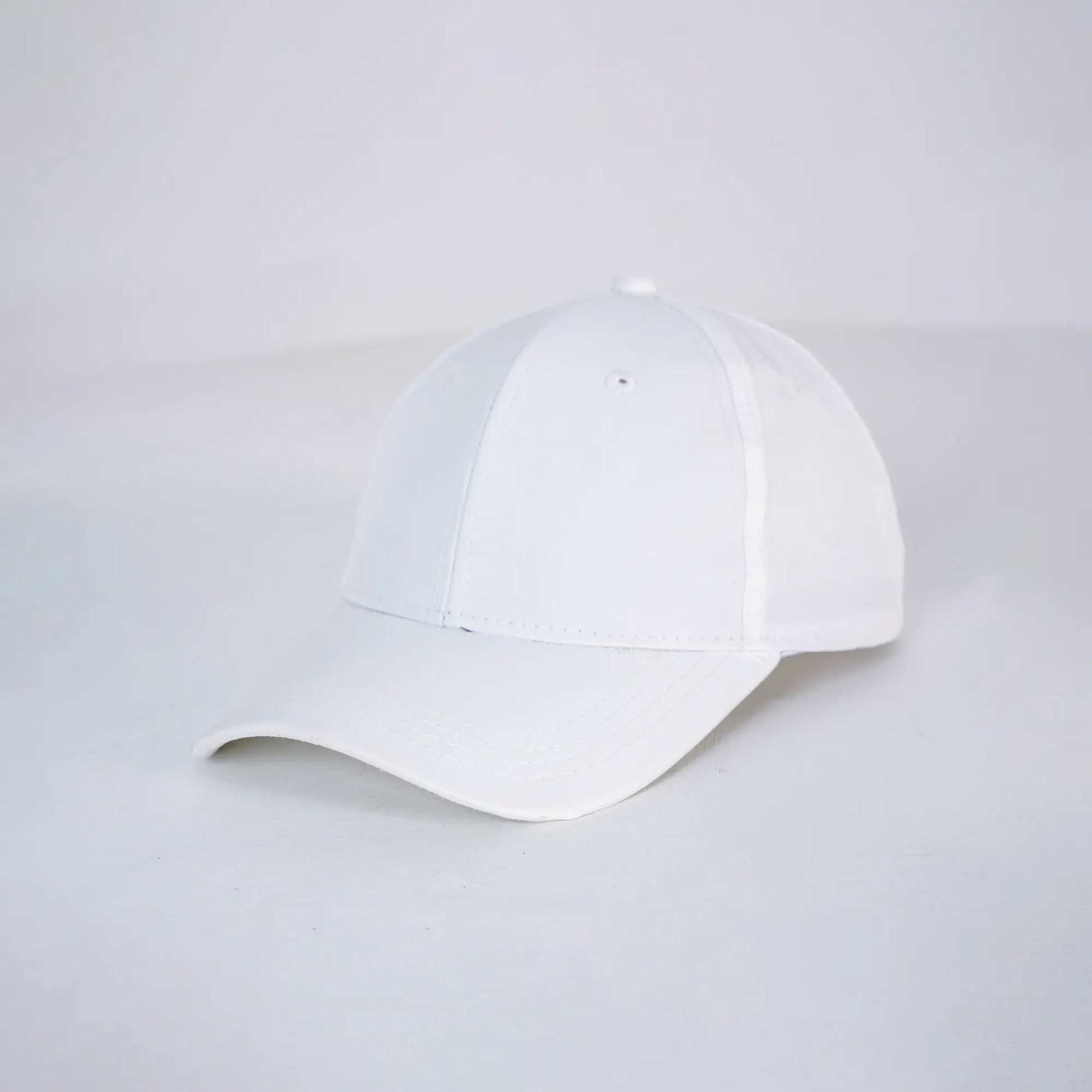 White baseball cap on a light gray background