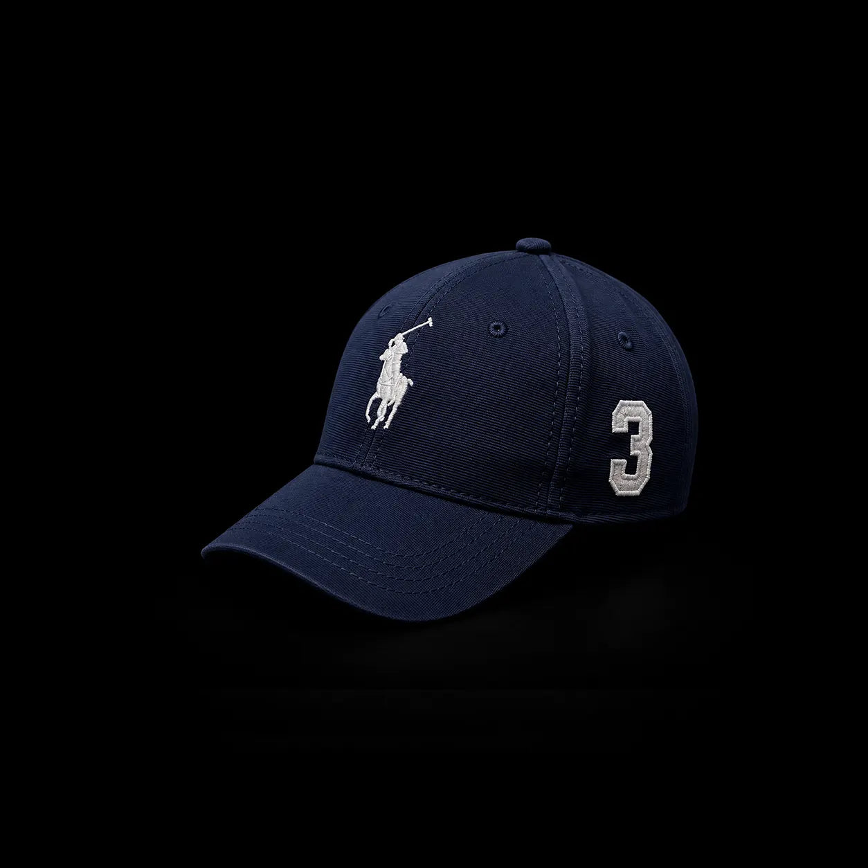 A navy blue Polo Ralph Lauren baseball cap featuring the embroidered white polo player logo on the front and the number 3 on the side, set against a solid black background.