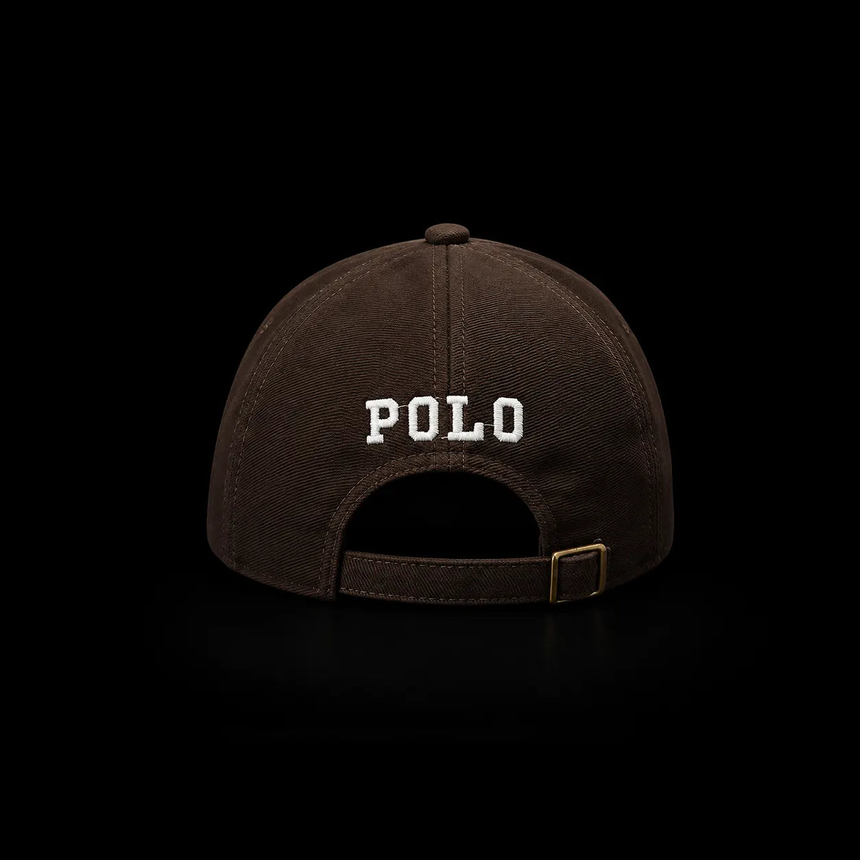 Ralph Lauren Polo brand brown baseball cap shown from the back, featuring white embroidered 'POLO' text and a gold-tone buckle on a solid black background.