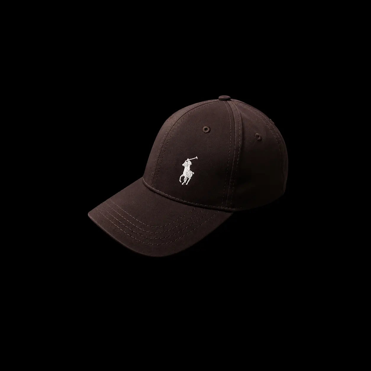 A dark brown Polo Ralph Lauren baseball cap with a white embroidered polo player logo on the front, shown against a solid black background.