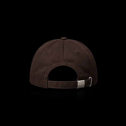 The back view of a dark brown baseball cap with an adjustable strap and a silver metal slider buckle, shown against a solid black background.