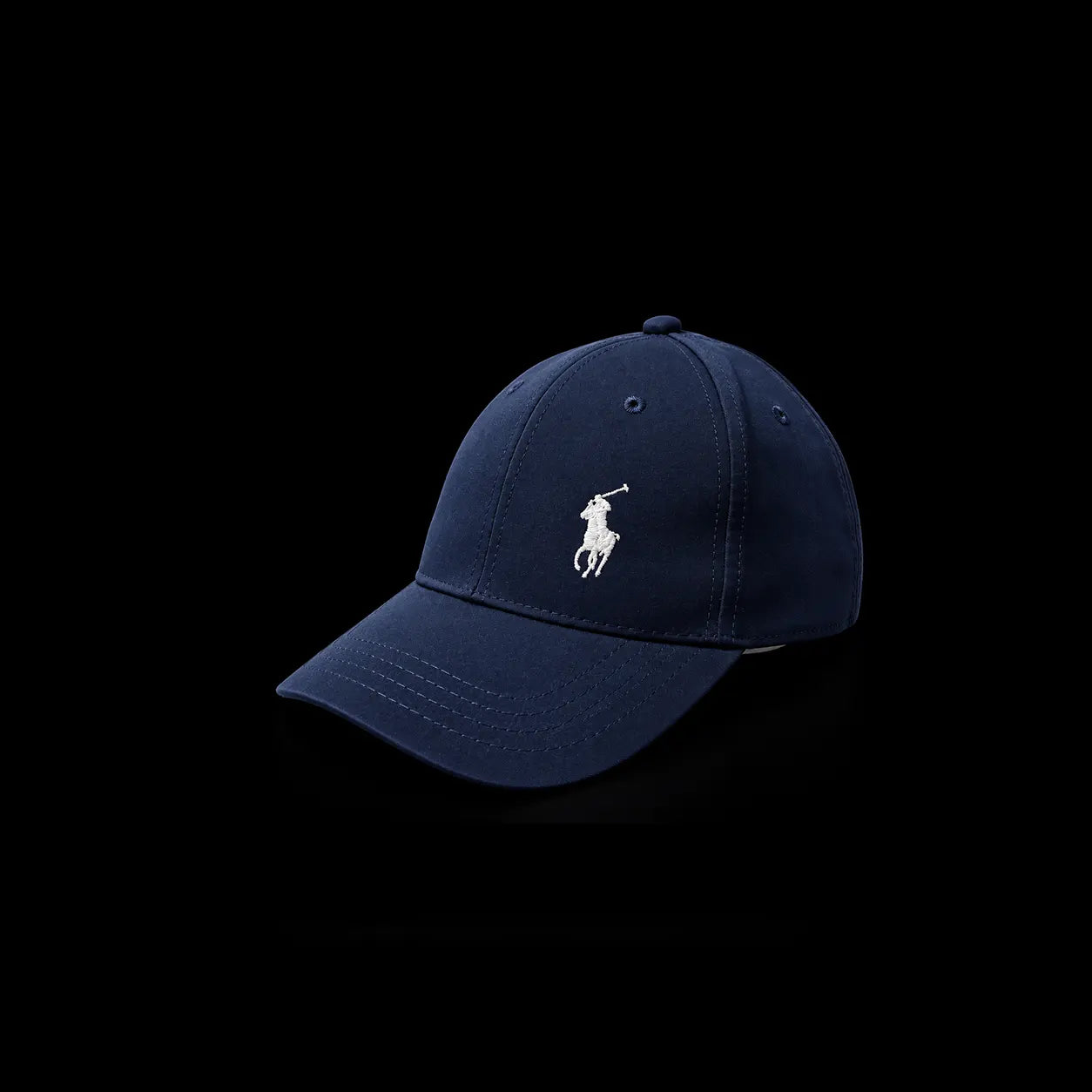 A navy blue baseball cap with the white embroidered Polo Ralph Lauren pony logo on the front, set against a solid black background.