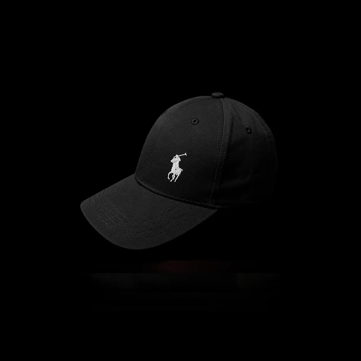 A black baseball cap featuring the white embroidered Polo logo on the front, set against a solid black background.
