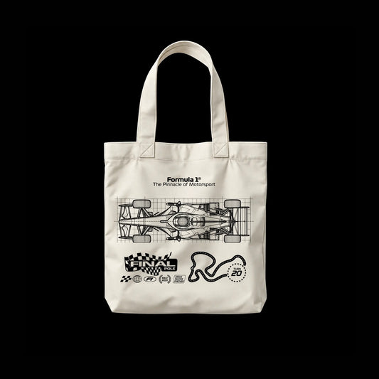 An off-white canvas tote bag with black graphic prints of a Formula 1 car, track map, and checkered flag, displayed against a solid black background.