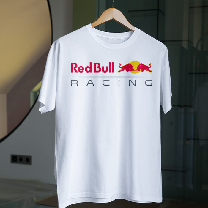 A male model wearing a black Red Bull Racing logo T-shirt with short sleeves and a classic crew neckline.