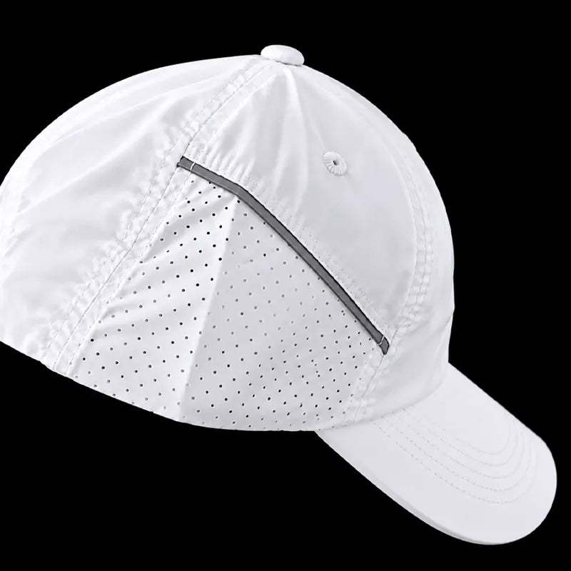 A white baseball cap with a curved brim, featuring a diagonal reflective gray stripe and a small circular logo on the front panel, set against a solid black background.
